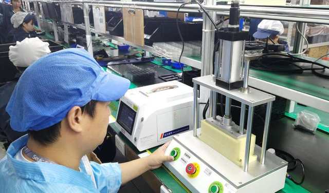 Technicians at Barway Barcode operating machinery in the production line for barcode and RFID hardware.